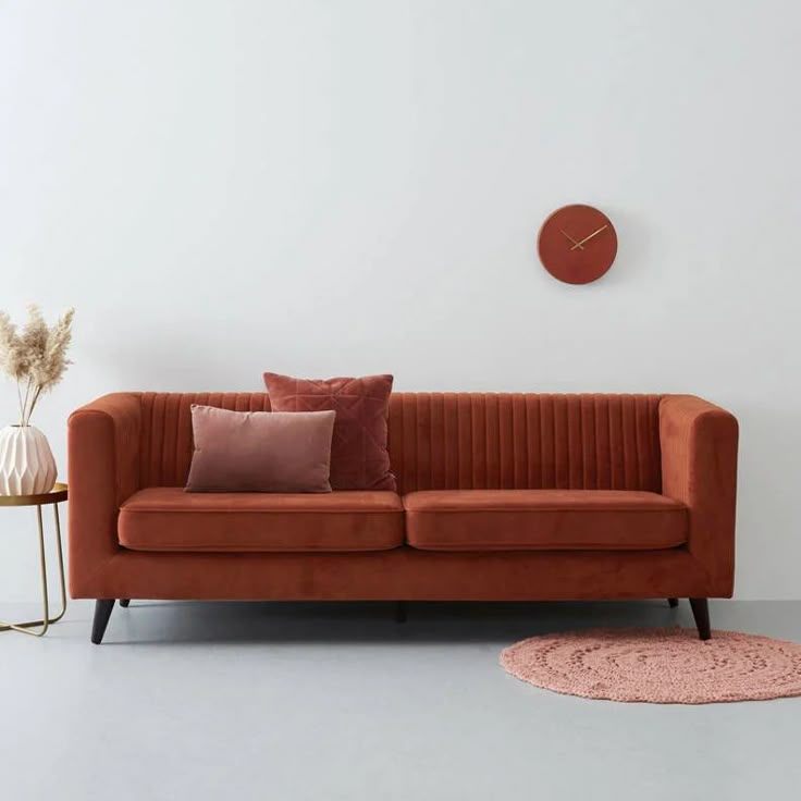 Armchair reupholstered in soft taupe textured fabric in a warm interior