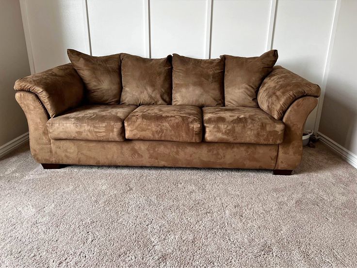 Old armchair with dated, worn floral fabric upholstery